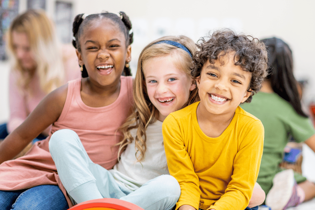 Smiling children in a classroom setting — supports CAPS-aligned content for Beginning Knowledge and personal and social well-being on grade.co.za, promoting emotional growth, social skills, and confident peer interaction.