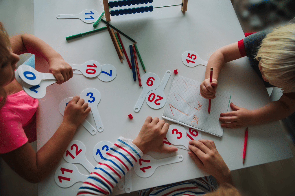 Children engaging with number cards and writing tools — supports early pattern recognition, sequencing, and algebraic thinking with CAPS-aligned numeracy activities on grade.co.za for Grades 1 to 3.