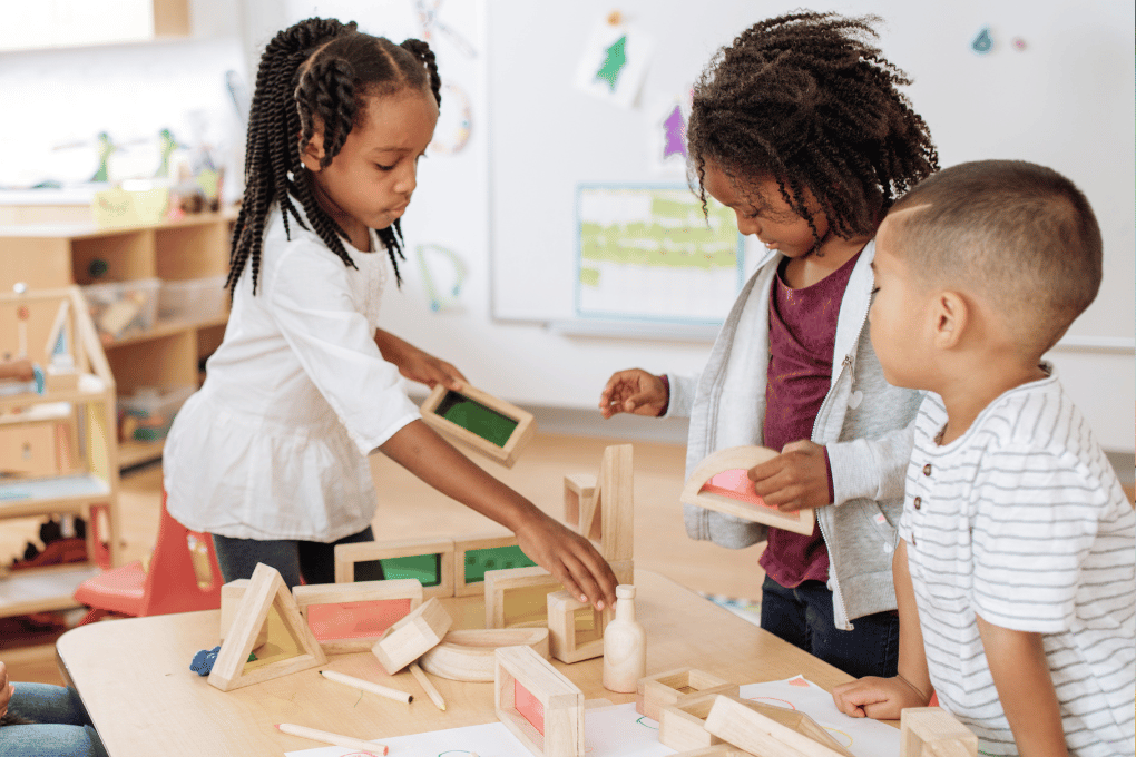 Children working with wooden blocks to learn about shapes and space — ideal for developing early geometry and spatial awareness using grade.co.za’s CAPS-based activities for Grades R to 2.