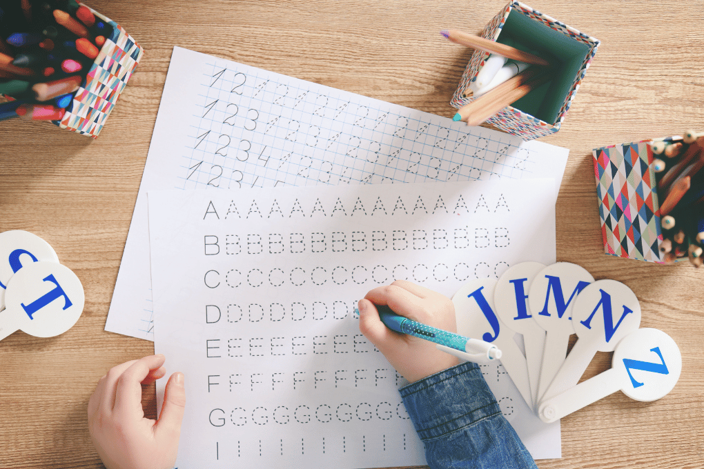 Child tracing letters and numbers on handwriting worksheets — supports fine motor development, letter formation, and early writing skills using CAPS-aligned foundation phase resources from SpecCon Academy