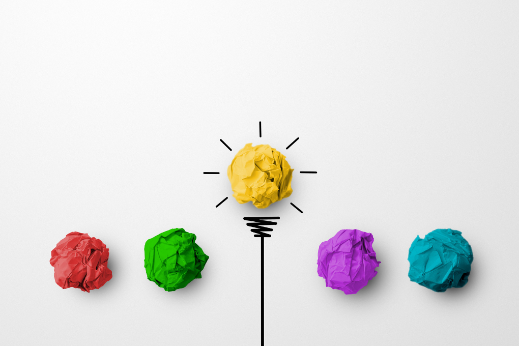 Crumpled coloured paper arranged as a lightbulb symbolising creative ideas