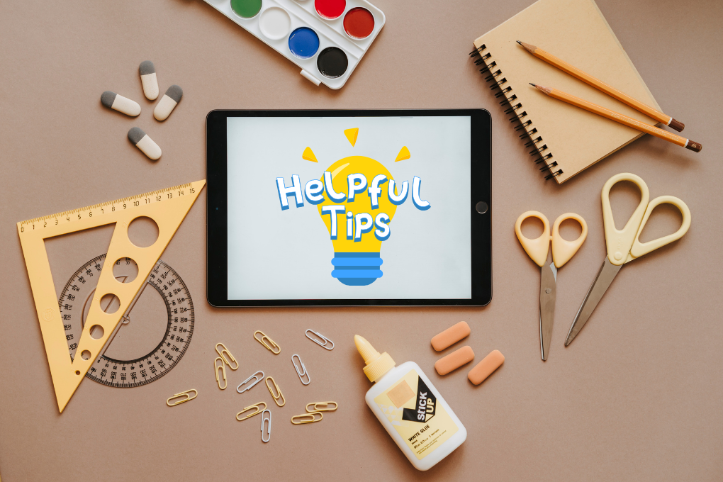 Tablet on desk displaying ‘Helpful Tips’ surrounded by school stationery